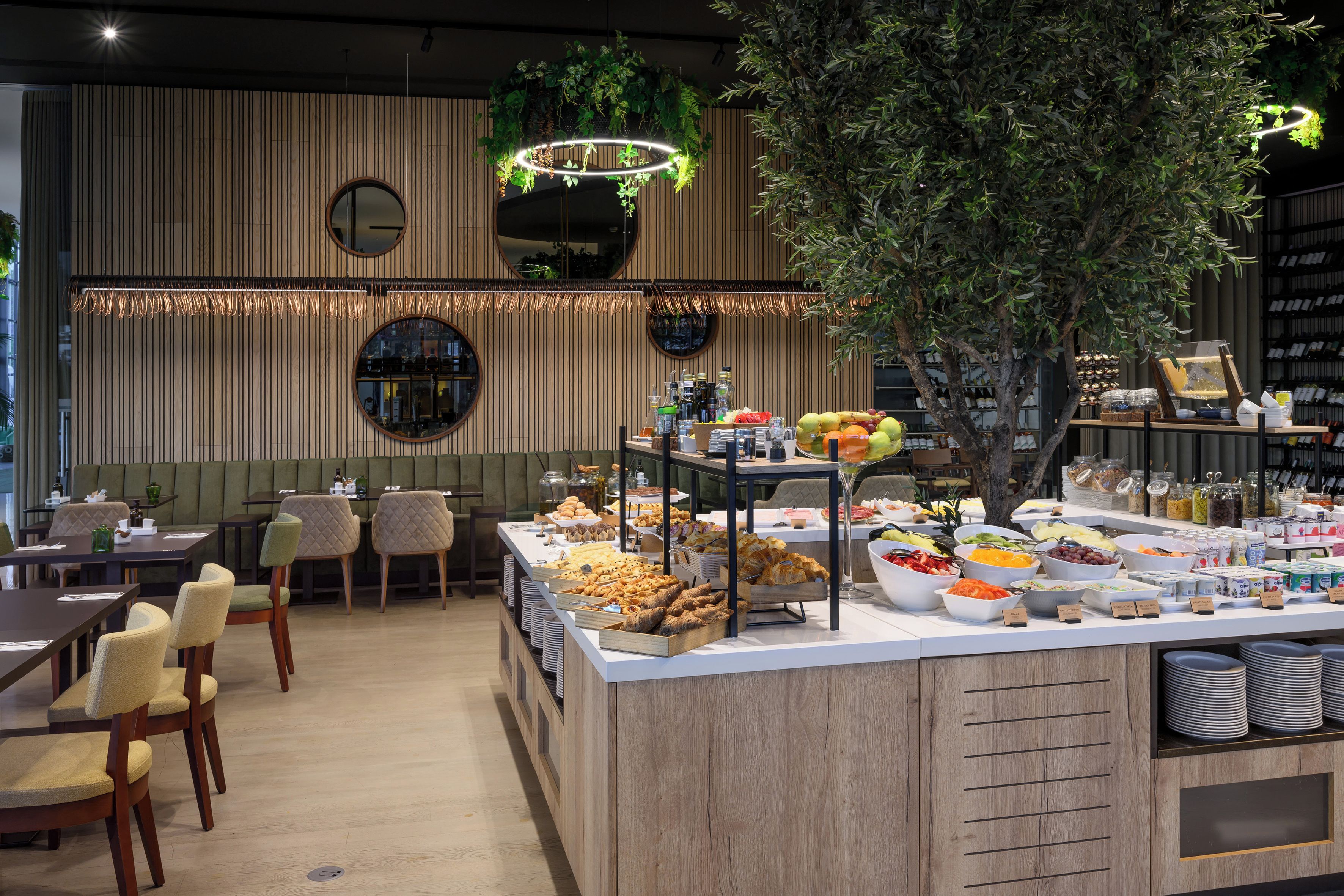 A buffet area with various food items and a seating area with chairs and tables.