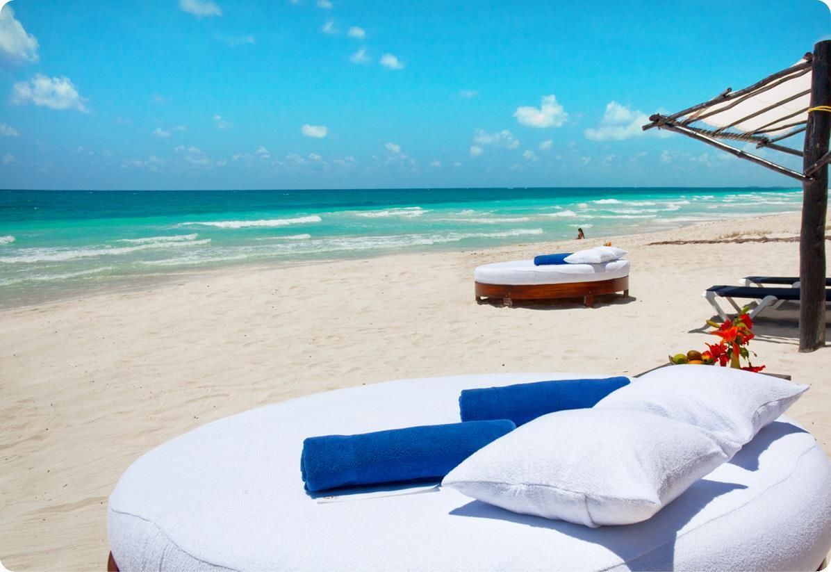 On the beach, white sand, sun loungers, beach umbrellas