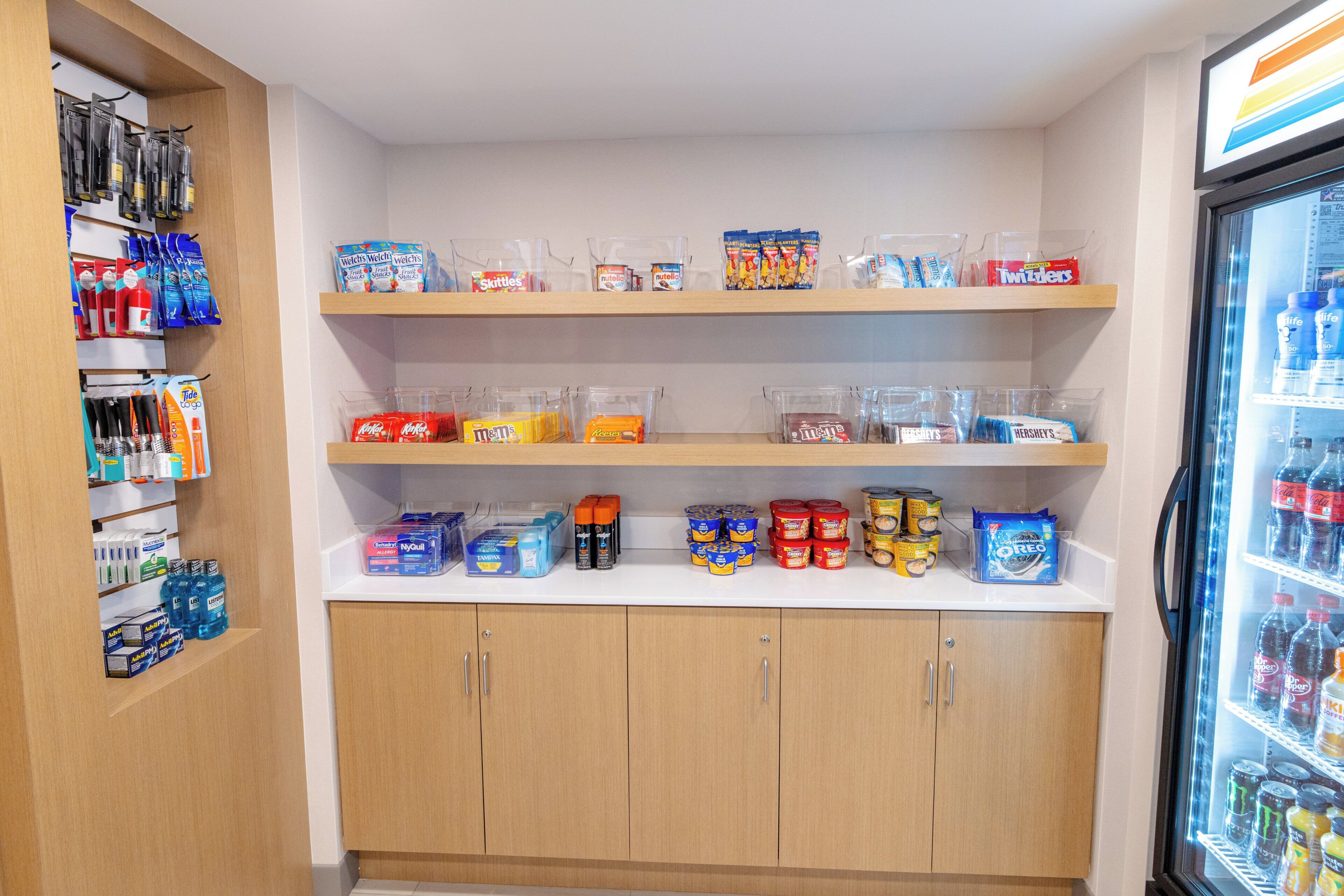 A well-organized pantry with shelves stocked with snacks, beverages, and household items.