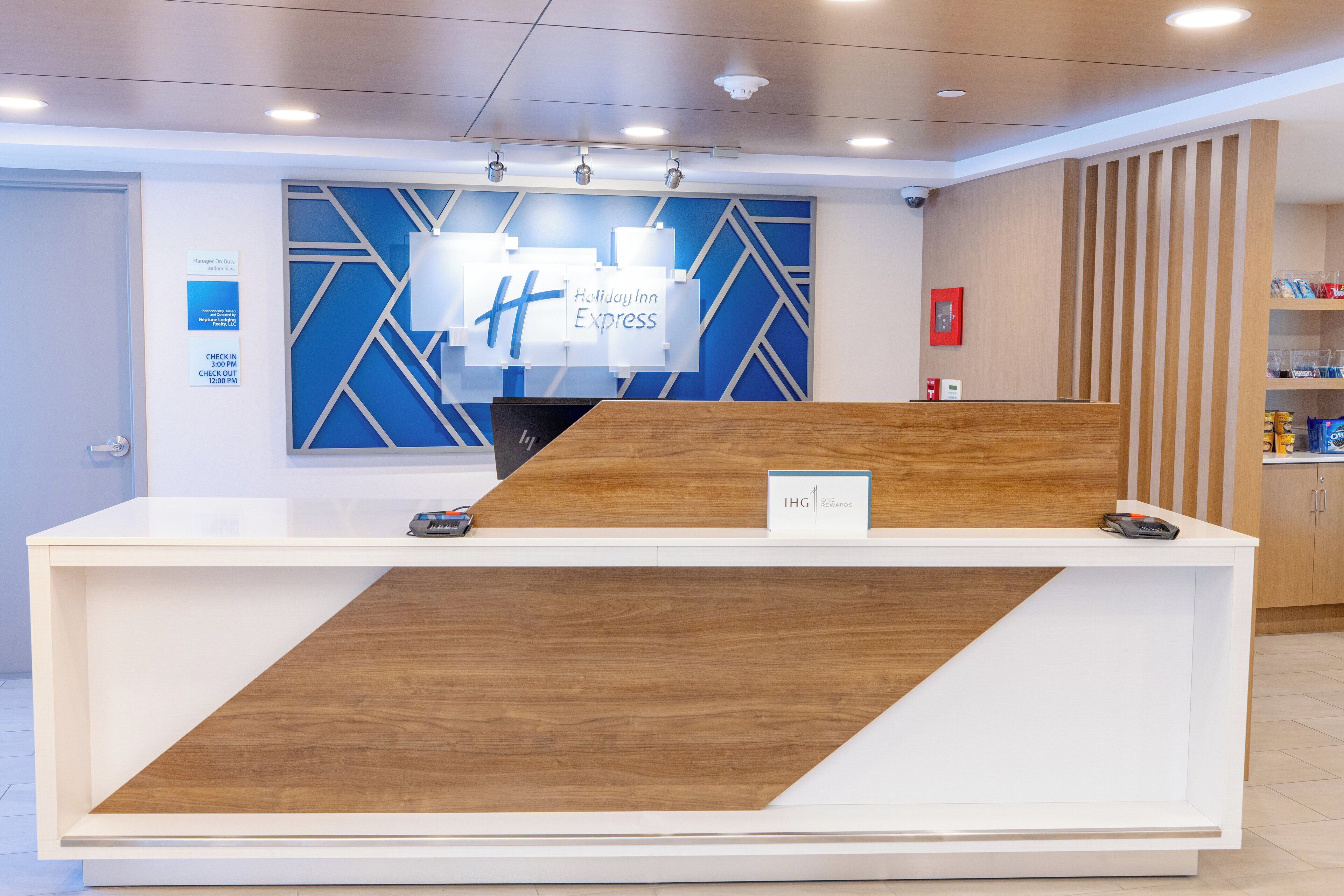 A reception desk with a modern design, featuring a wooden and white color scheme.