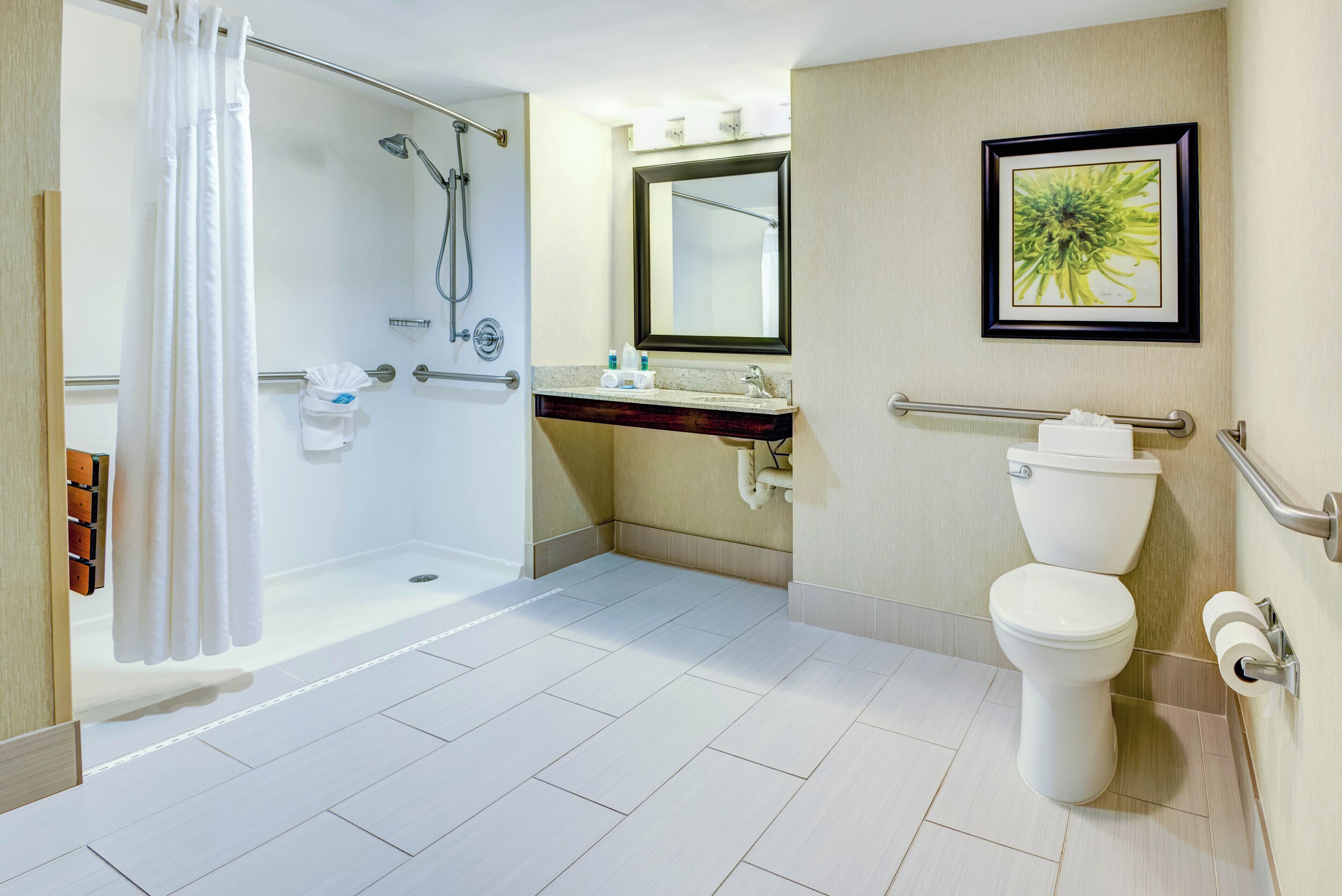 A modern bathroom with a walk-in shower, a toilet, and a sink.
