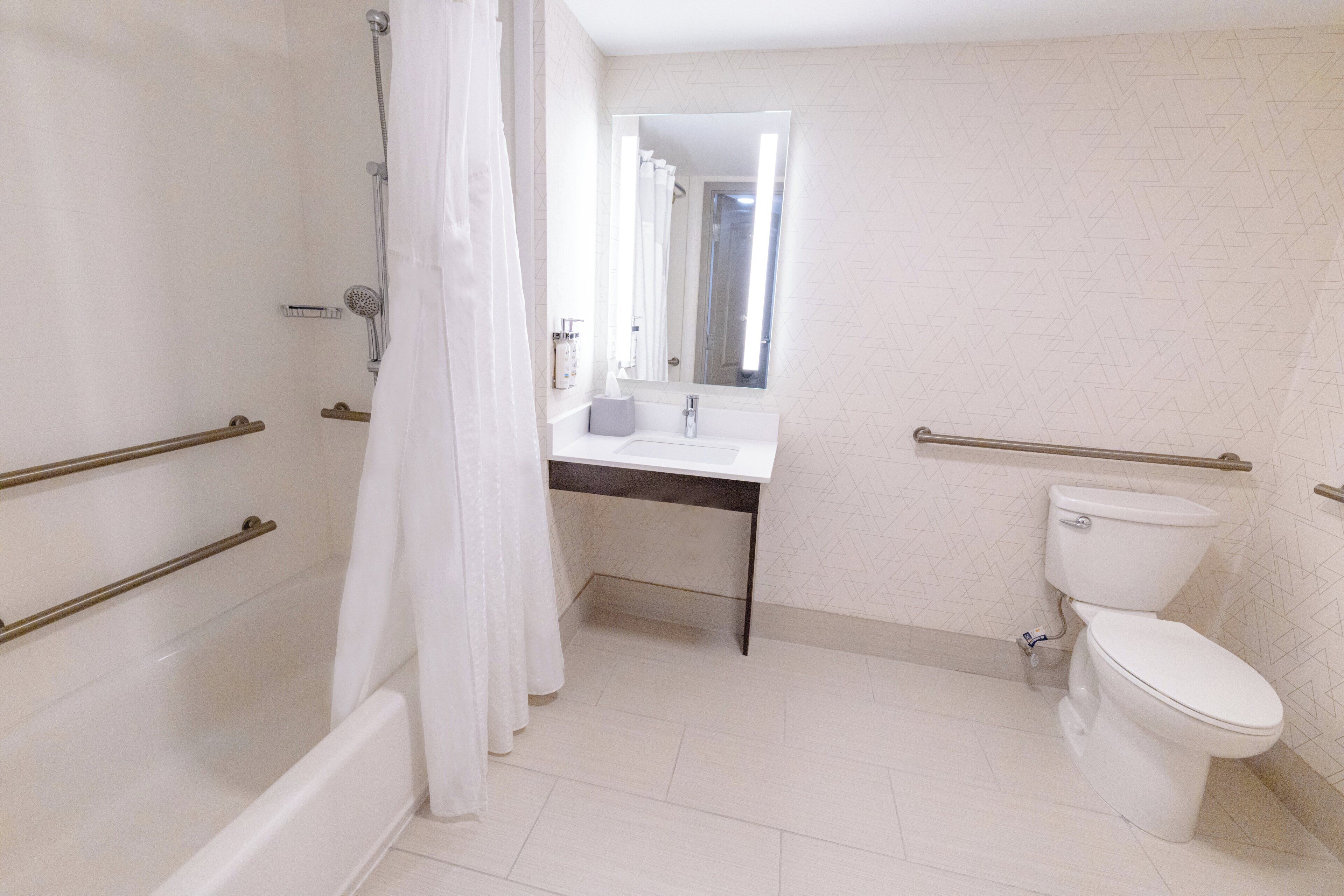 A bathroom with a shower, toilet, and sink.