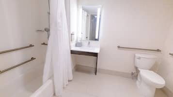 A bathroom with a shower, toilet, and sink.
