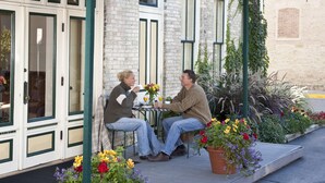 A covered outdoor seating area with a green awning labeled "The Washington House Inn." - Washington House Inn (Cedarburg)