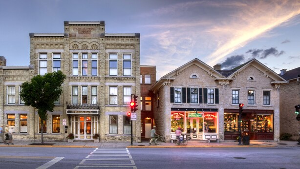 A historic building with a prominent entrance, large windows, and a street view. - Washington House Inn (Cedarburg)