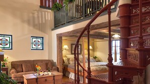 A cozy room with a wooden four-poster bed, a sofa, and a chest of drawers. - Washington House Inn (Cedarburg)
