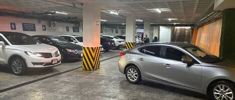 A multi-level parking garage with several cars parked.