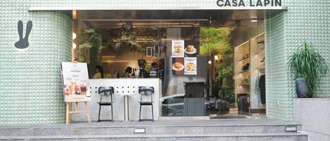 A storefront with a sign reading "CASA LAPIN" and a display of food items.