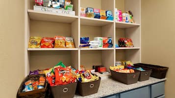 A pantry with snacks, toiletries, and cleaning supplies.