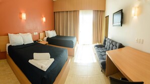 A hotel room with two beds, a sofa, a desk, and a TV. - La Isla Huatulco (Santa María Huatulco)