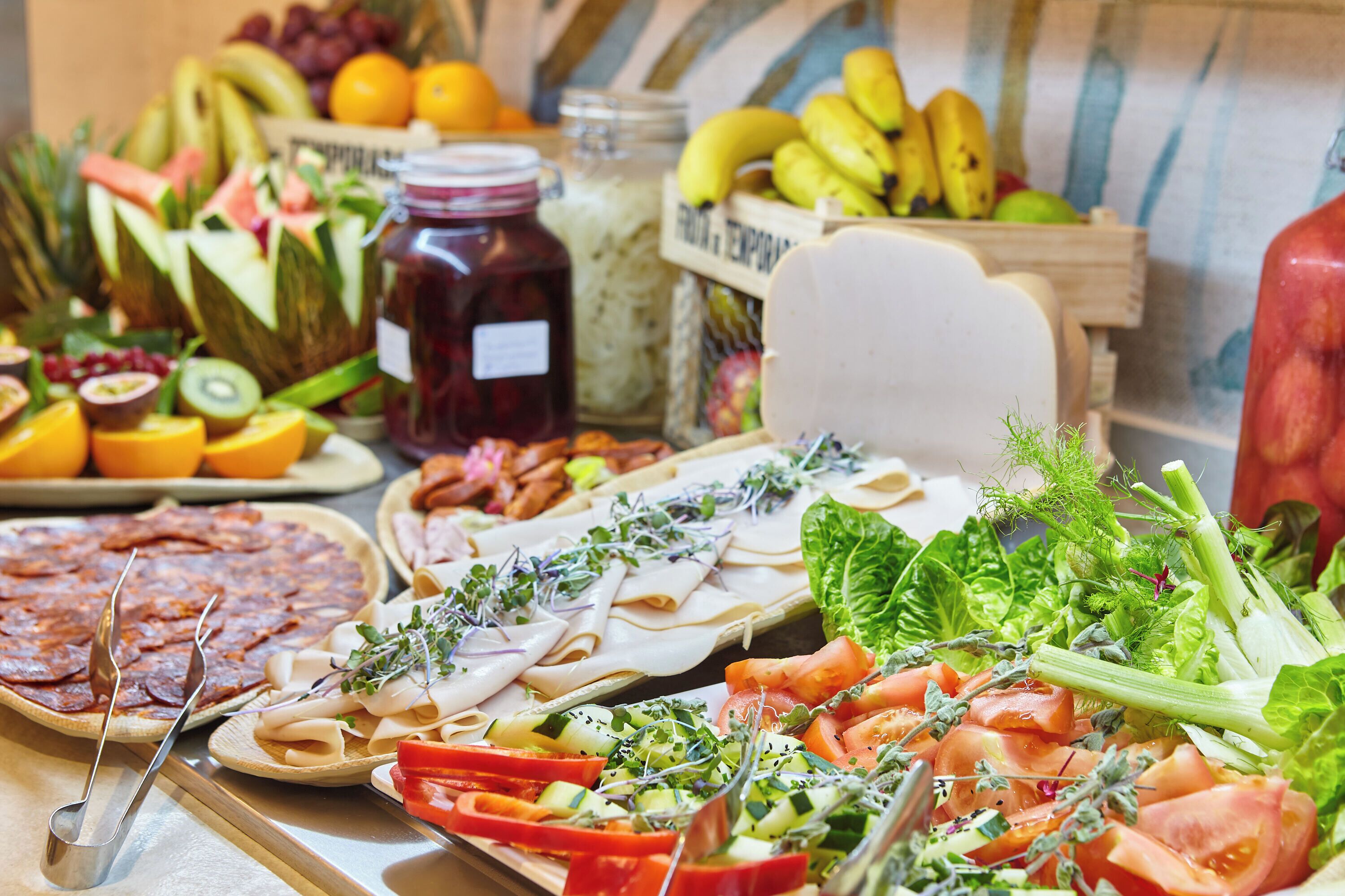 A variety of food items including fruits, vegetables, and prepared dishes on a table.