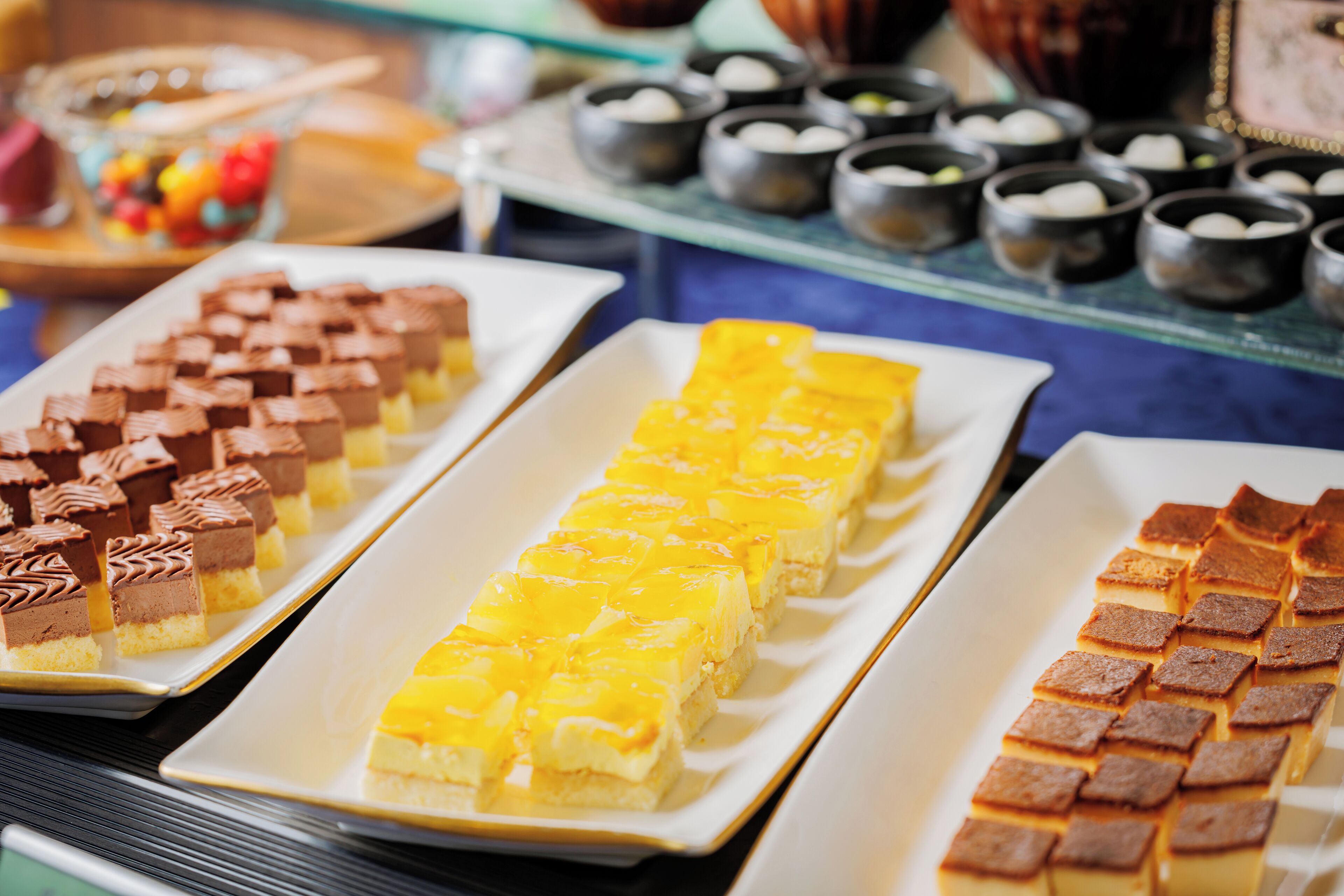 A display of various desserts on trays.