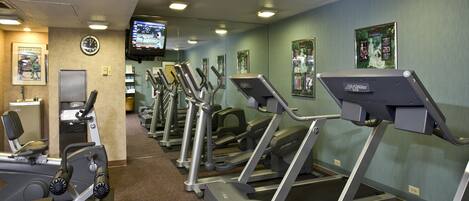 A gym with treadmills, ellipticals, and weight machines.