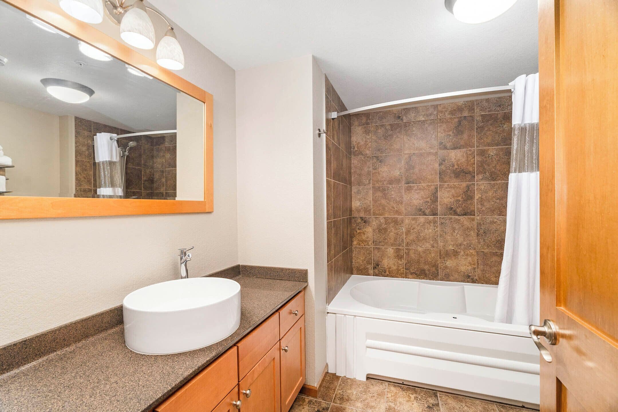 condo, 1 bedroom, lake view | bathroom | combined shower/bathtub, eco-friendly toiletries, hair dryer, towels