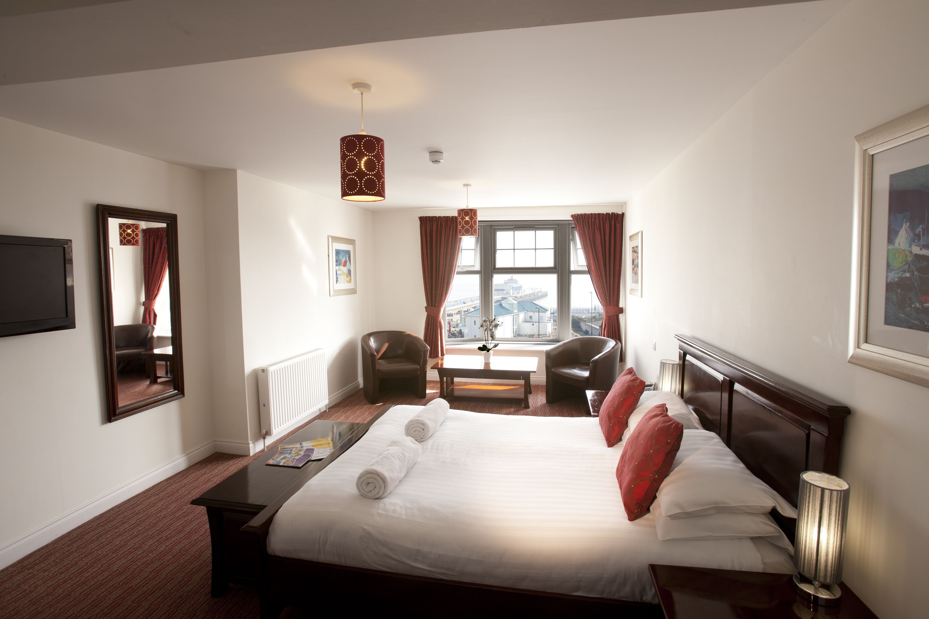 signature room | in-room safe, desk, blackout curtains, iron/ironing board