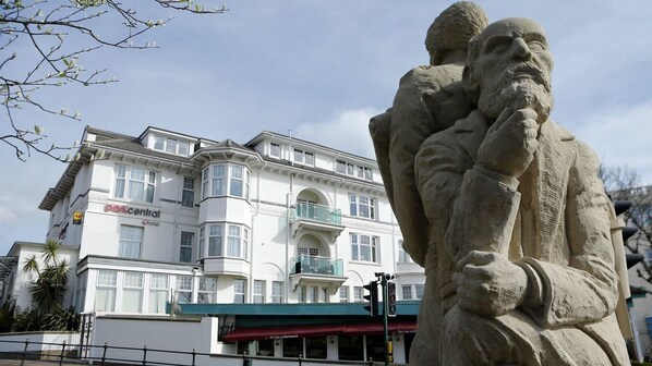 A building with a sign reading "Berkcenter" and a statue of two figures in the foreground. - Sea Stone Hotel (Bournemouth)