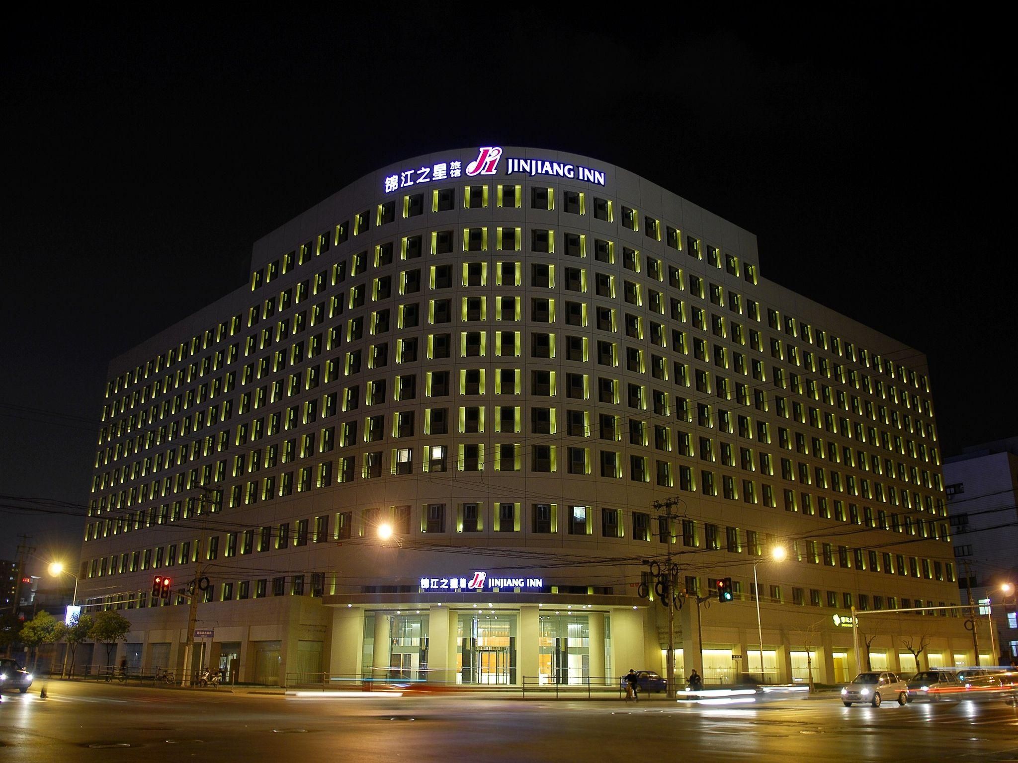 A multi-story hotel with a prominent signage at the top.