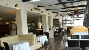 A spacious restaurant with high ceilings, modern lighting, and a mix of seating arrangements including tables and booths. - Jinjiang Inn Shanghai Zhangjiang Road (Shanghai)