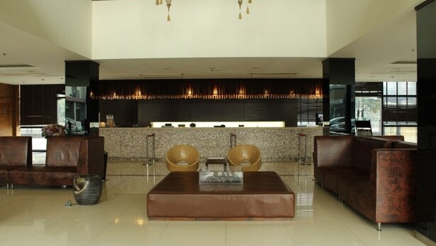A modern lobby with a reception desk, seating area, and a fireplace. - Jinjiang Inn Shanghai Zhangjiang Road (Shanghai)