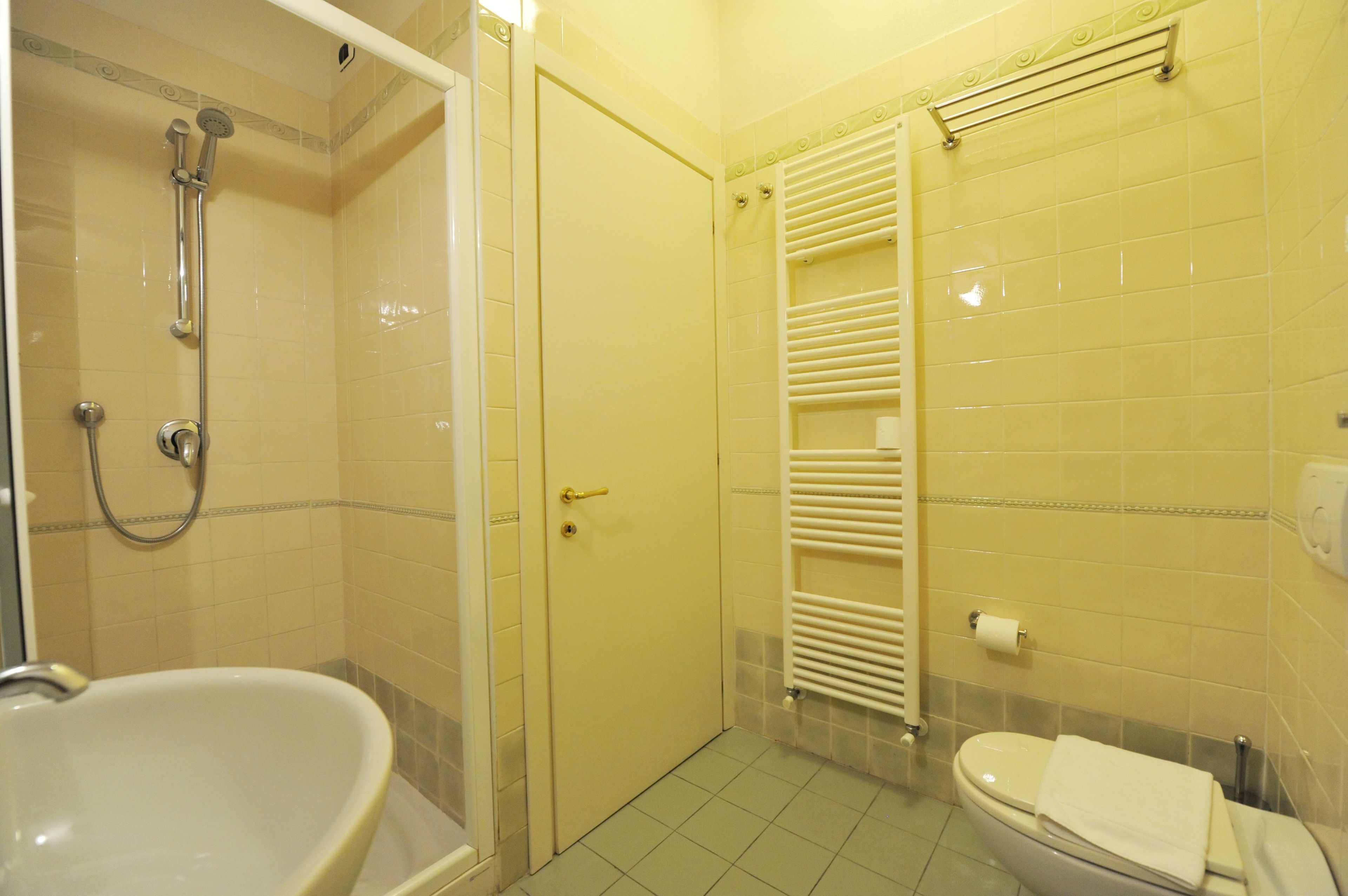 A bathroom with a bathtub, toilet, and shower.