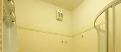 A small bathroom with a sink, toilet, and shower.