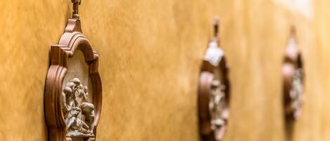 A row of wooden wall-mounted light fixtures with a classical design.