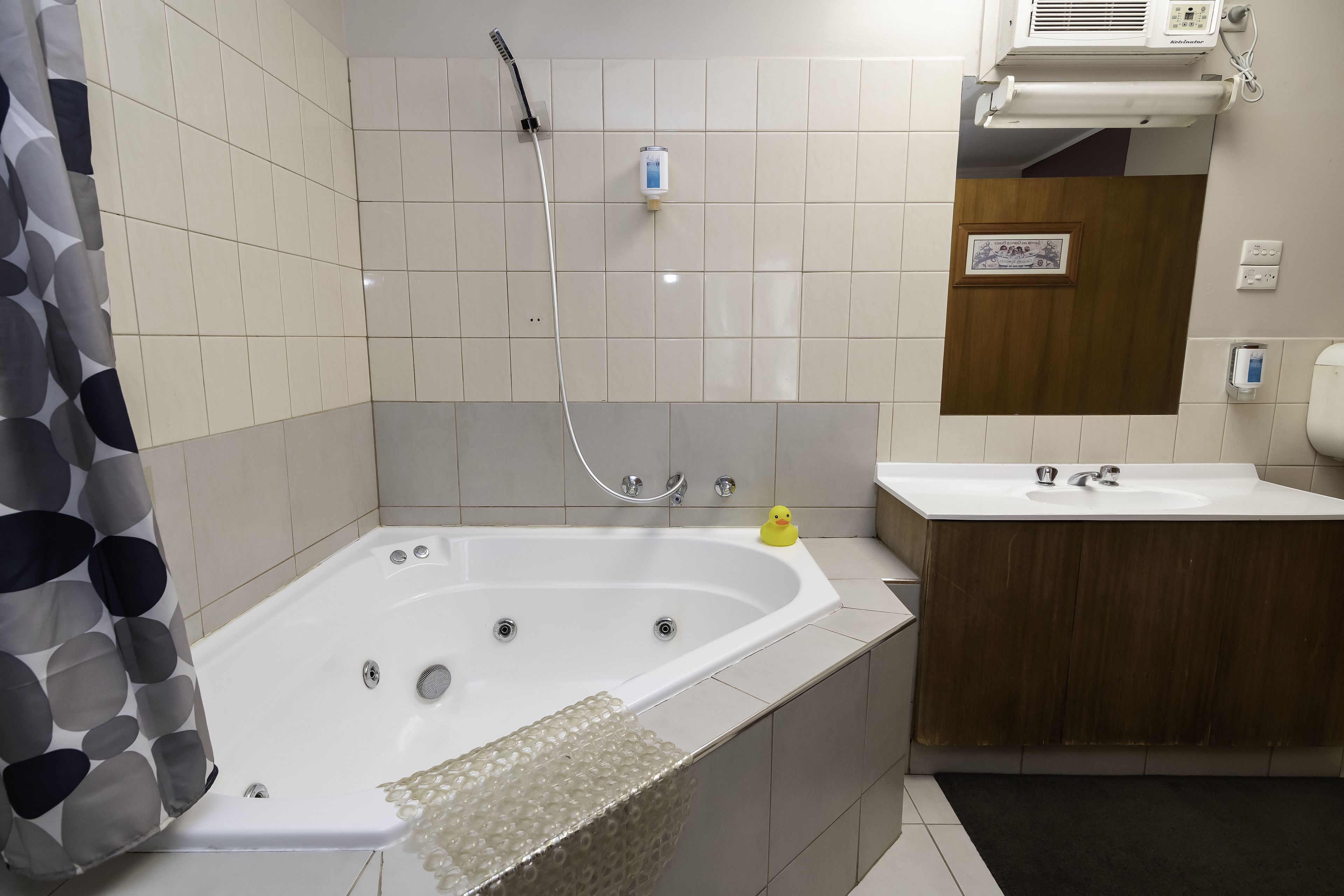A bathroom with a bathtub, a shower, a sink, and a toilet.
