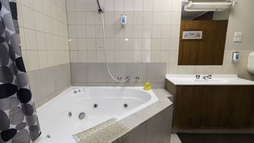A bathroom with a bathtub, a shower, a sink, and a toilet.