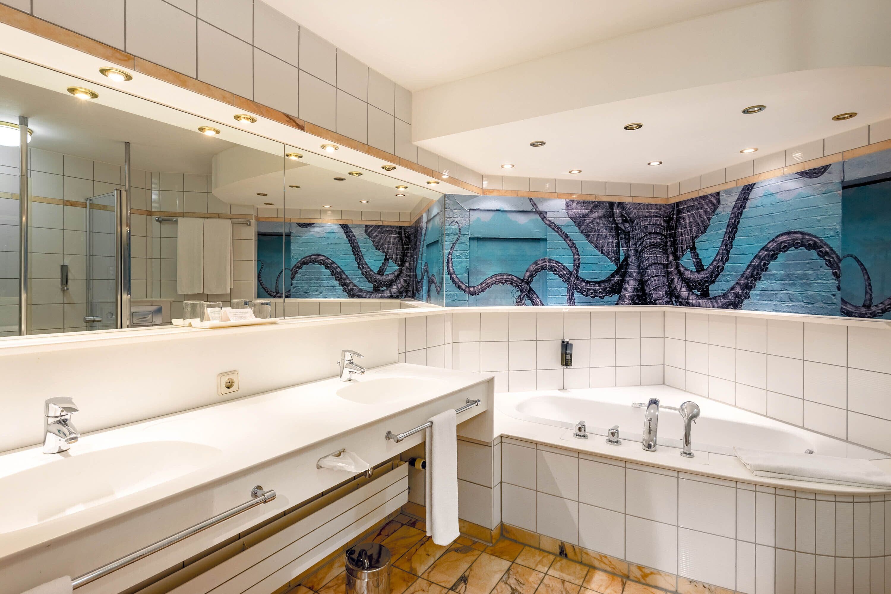A modern bathroom with two sinks, a bathtub, and a large mirror.
