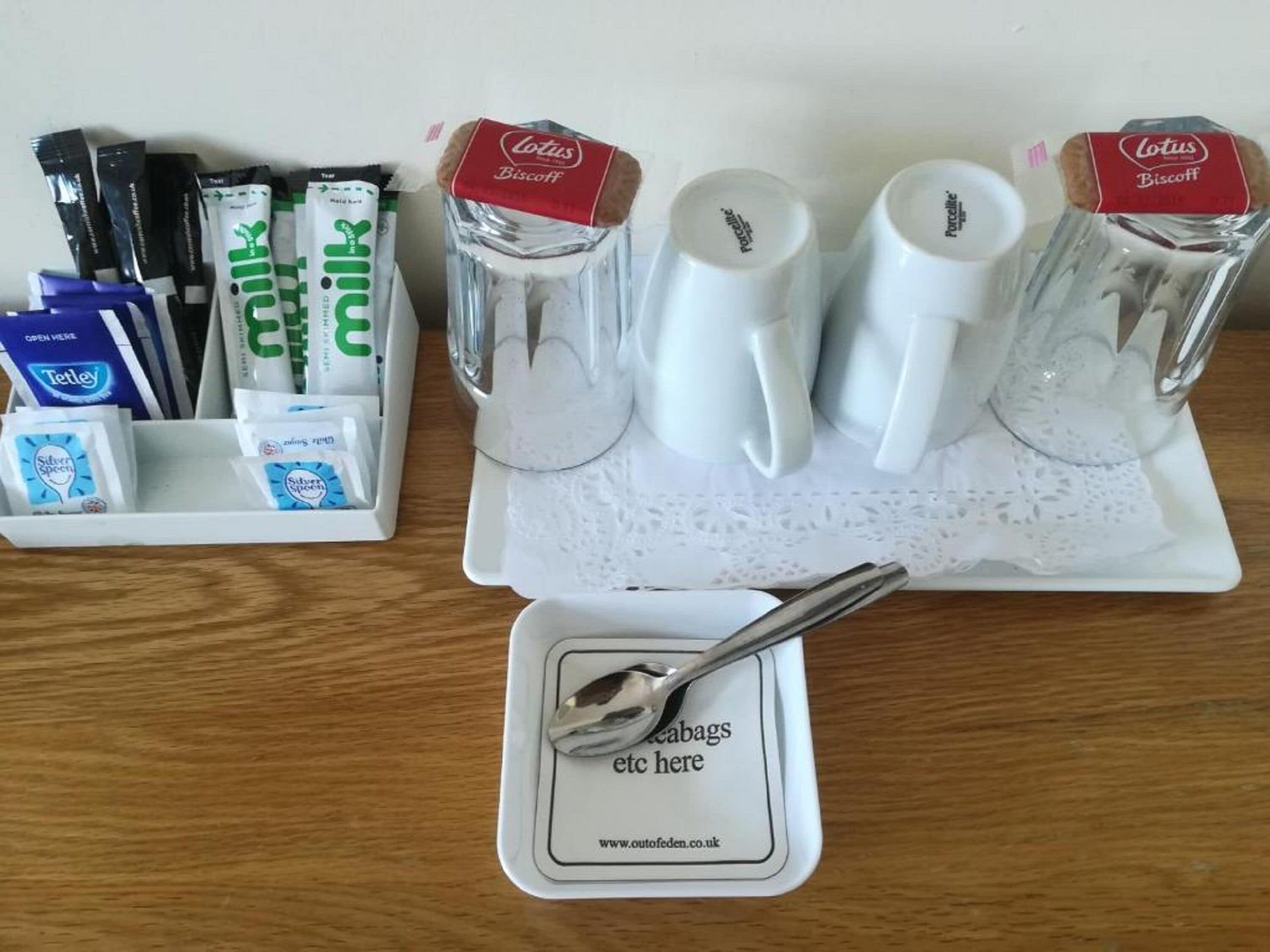 Un plateau de petit-déjeuner comprenant une cuillère, une assiette avec un mot et un ensemble de couverts.