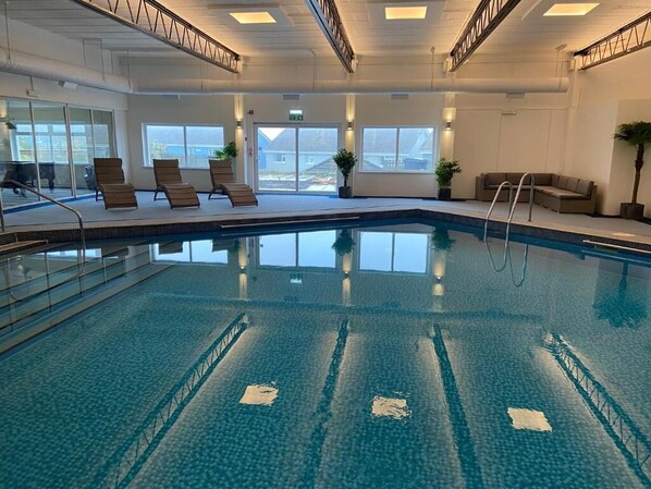 Indoor pool, open 7:30 AM to 8:30 PM, pool loungers