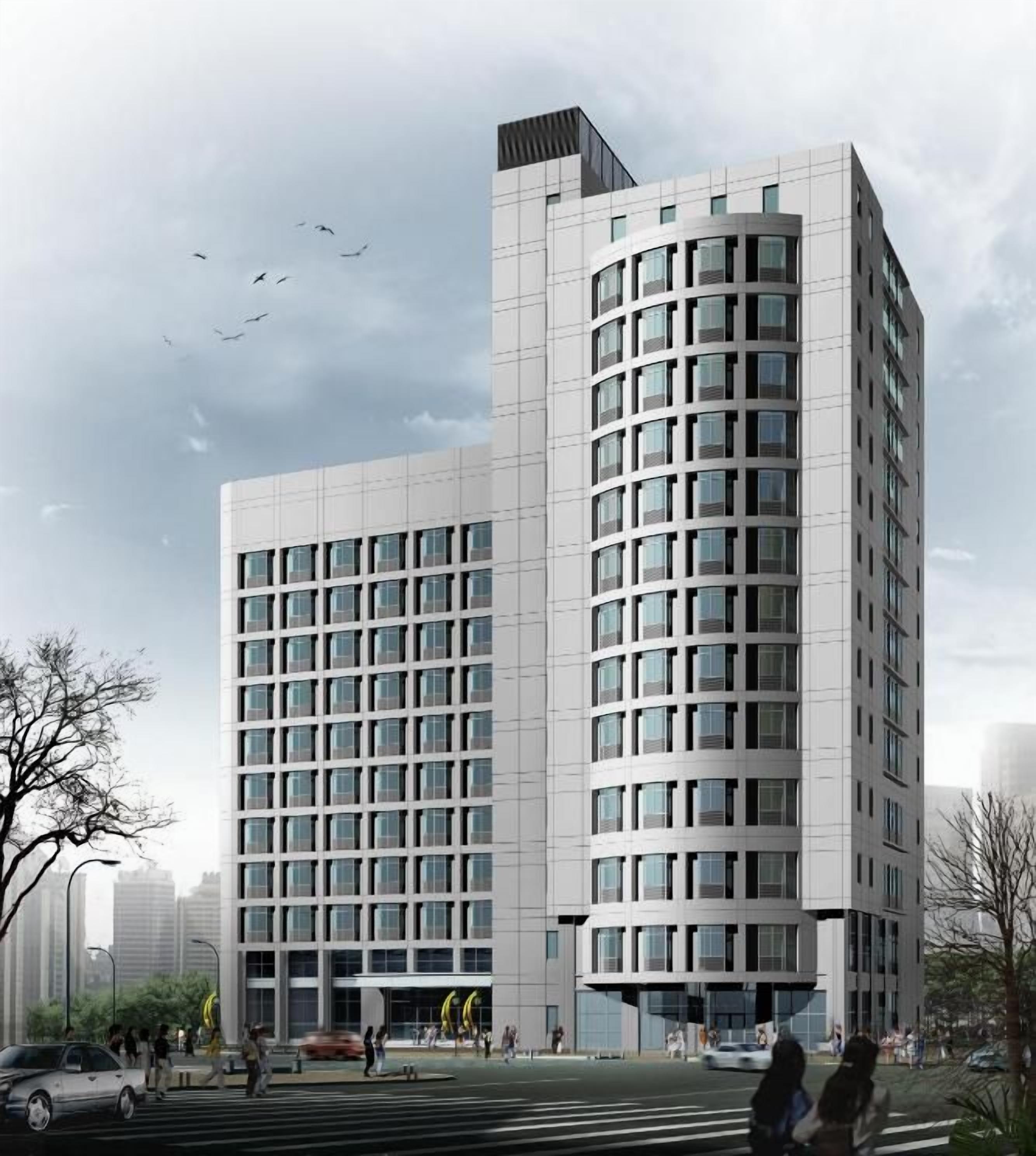 A modern multi-story building with a grid-like facade and large windows.