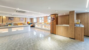 A modern hotel lobby with a central reception desk, a buffet area, and a clean, polished floor. - Holiday Inn Express Suzhou Shantang Street (Suzhou)