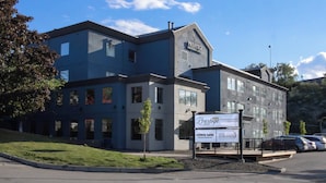 A modern building with a sign for 'Prestige Aberdeen Lodge' and 'Moon Work Chinese Restaurant'.