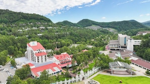 A hotel with multiple buildings, a parking lot, and a stage area.