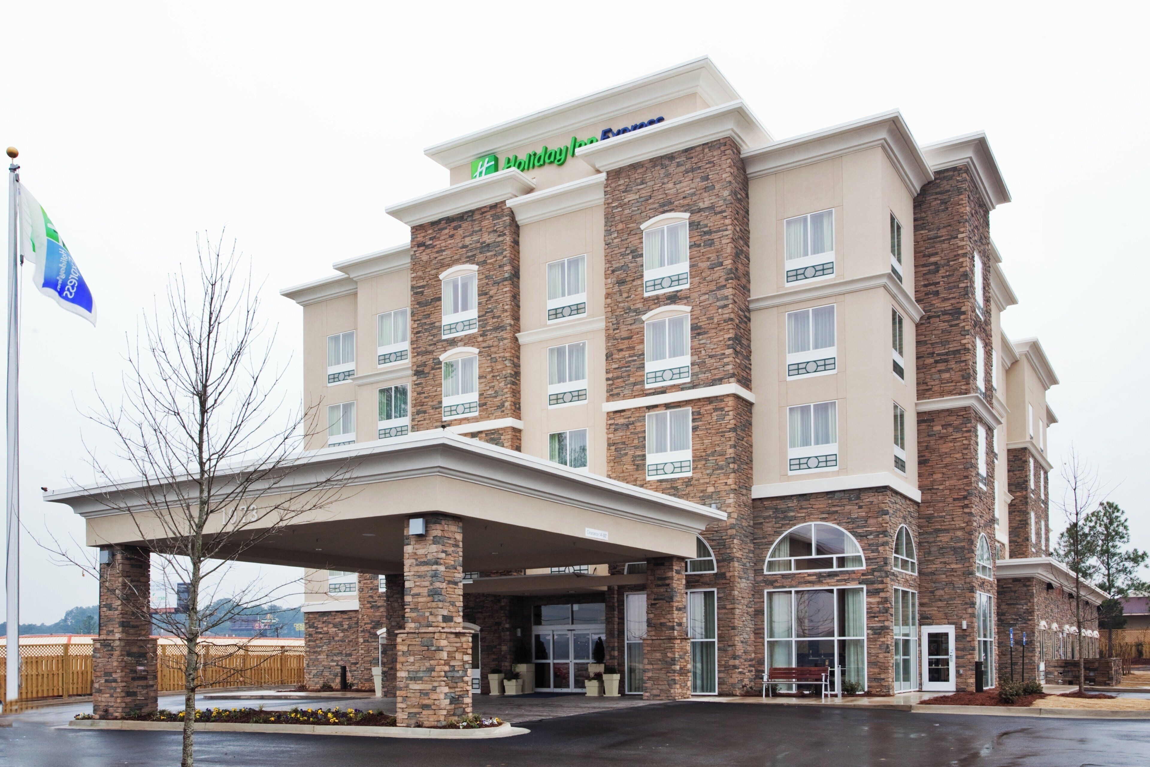 A Holiday Inn Express hotel with a brick facade, multiple windows, and a covered entrance.