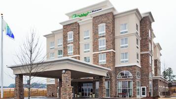 A Holiday Inn Express hotel with a brick facade, multiple windows, and a covered entrance.