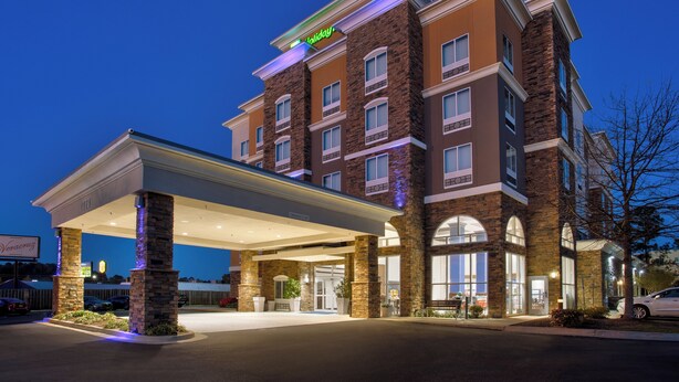 A multi-story hotel with a brick facade, a covered entrance, and a sign indicating it is a Holiday Inn Express. - Holiday Inn Express Augusta North by IHG (Augusta)
