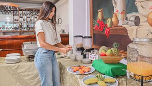 A buffet setup with various food items and a beverage dispenser. - TAMA Hotel Granada Real Cali (Cali)