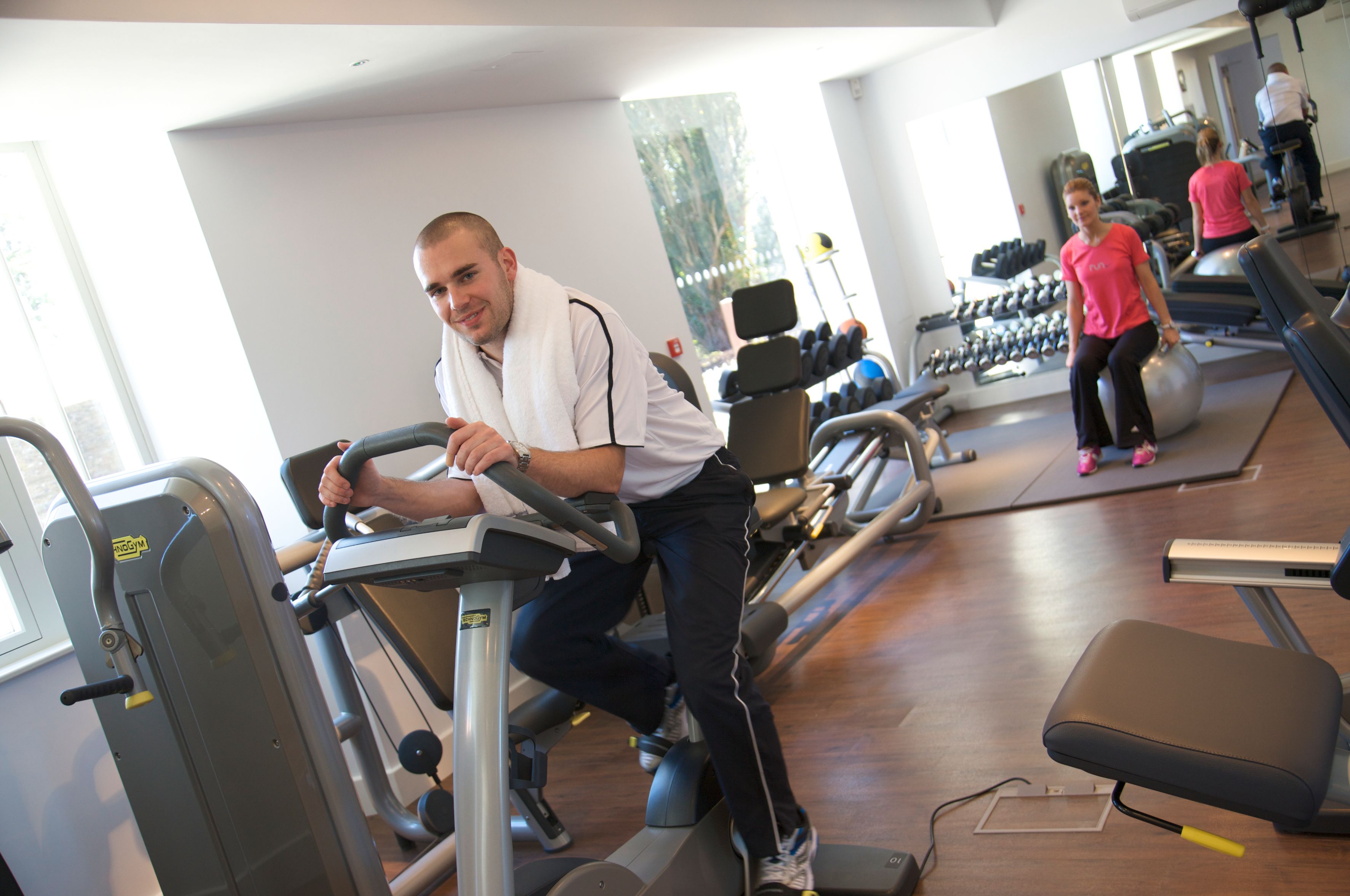 A gym with treadmills, weights, and exercise balls.
