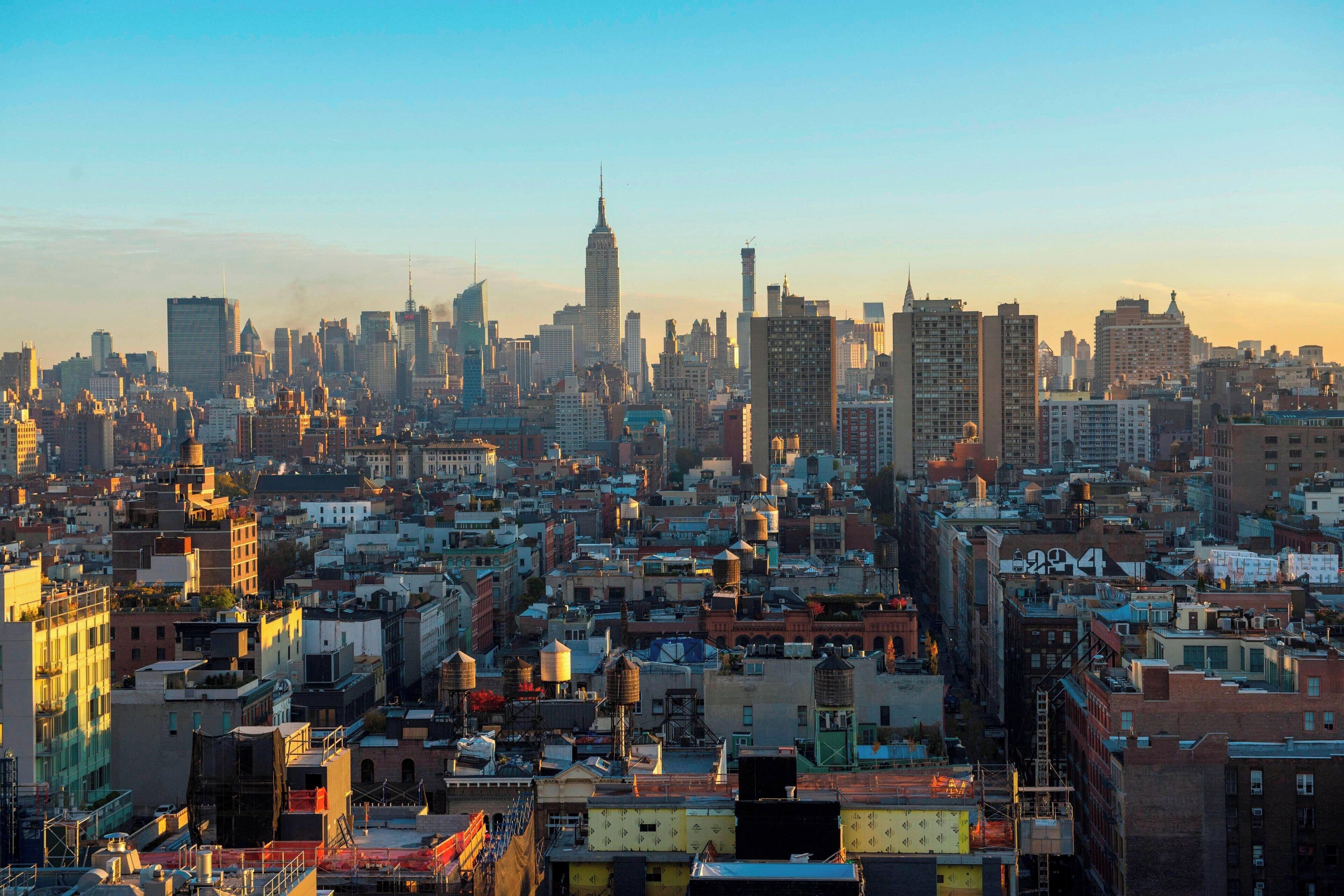 A dense urban skyline with a prominent skyscraper in the center.