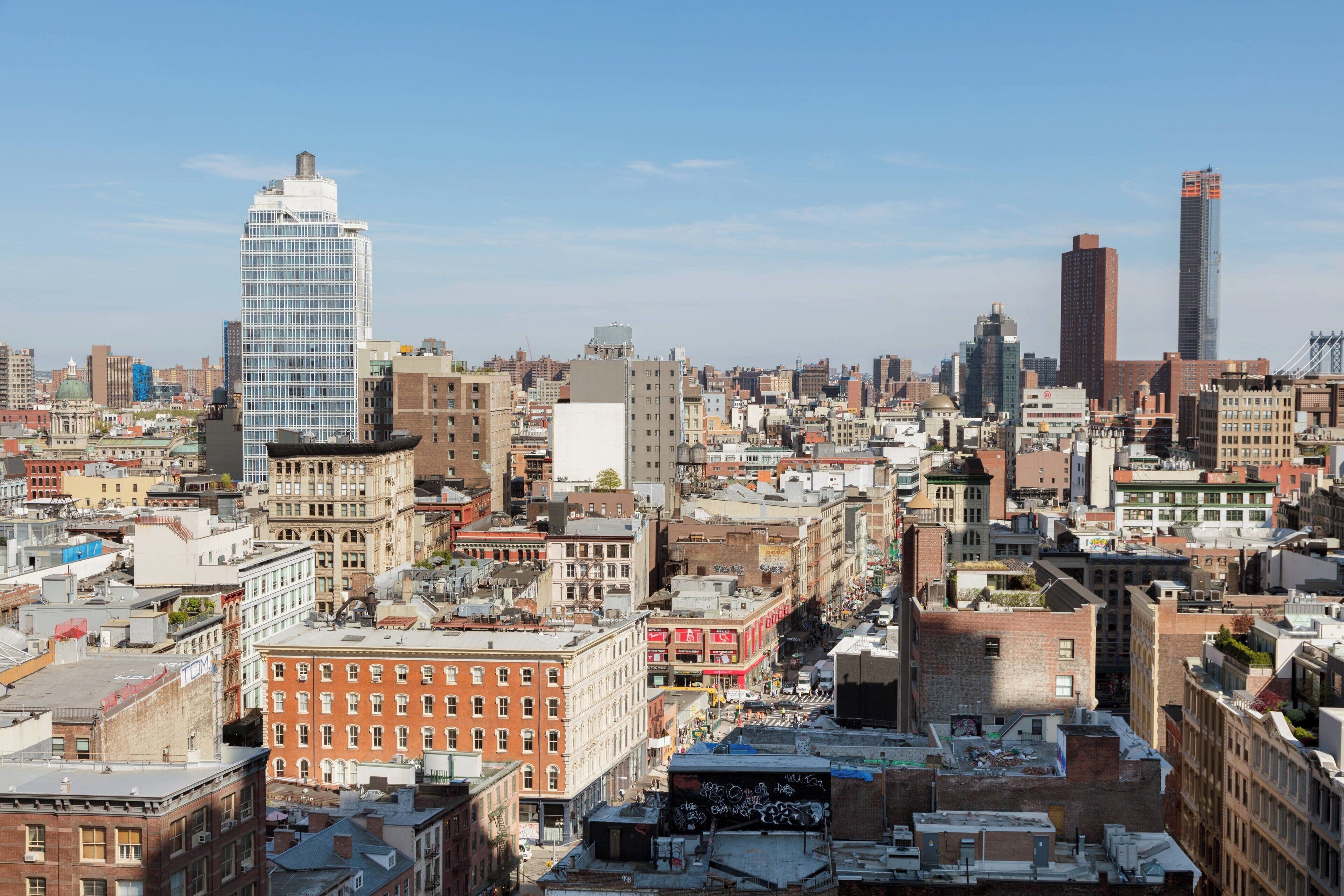 A cityscape with a variety of building styles, including modern skyscrapers and older, brick buildings.