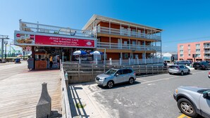 A multi-story building with a red sign for Jersey Shore Cafe. - Boardwalk Hotel Charlee & Beach House Rentals (Seaside Heights)