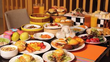 A buffet table with a variety of dishes including salads, meats, and pastries.