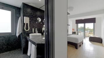 A modern bathroom with a large sink, mirror, and towel rack.