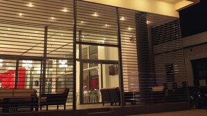 The exterior of the Patras Smart Hotel with a modern design, featuring a prominent signboard and a well-lit entrance. - Airotel Patras Smart (Patras)