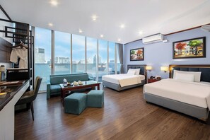 A hotel room with a large window, a sofa, a bed, a desk, and a chair. - A25 Premium Hotel - 12 Ngo Si Lien (Hanoi)