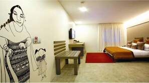A hotel room with a bed, a desk, a chair, a television, and a wall with a drawing. - The Park Pod (Chennai)
