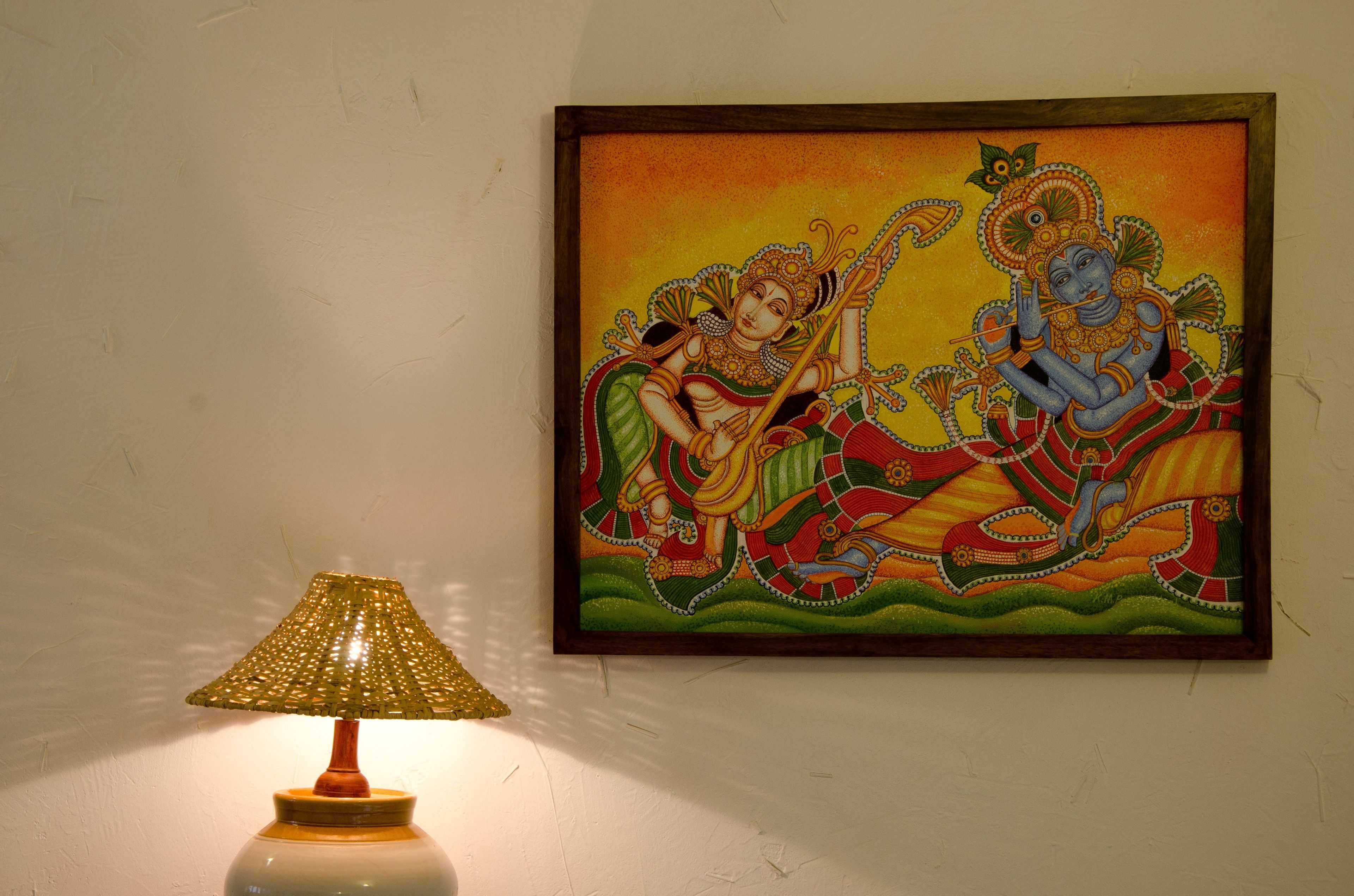 A framed painting on a wall, a lamp, and a textured wall surface.