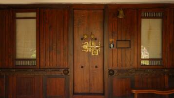 A wooden door with intricate carvings and a brass handle.